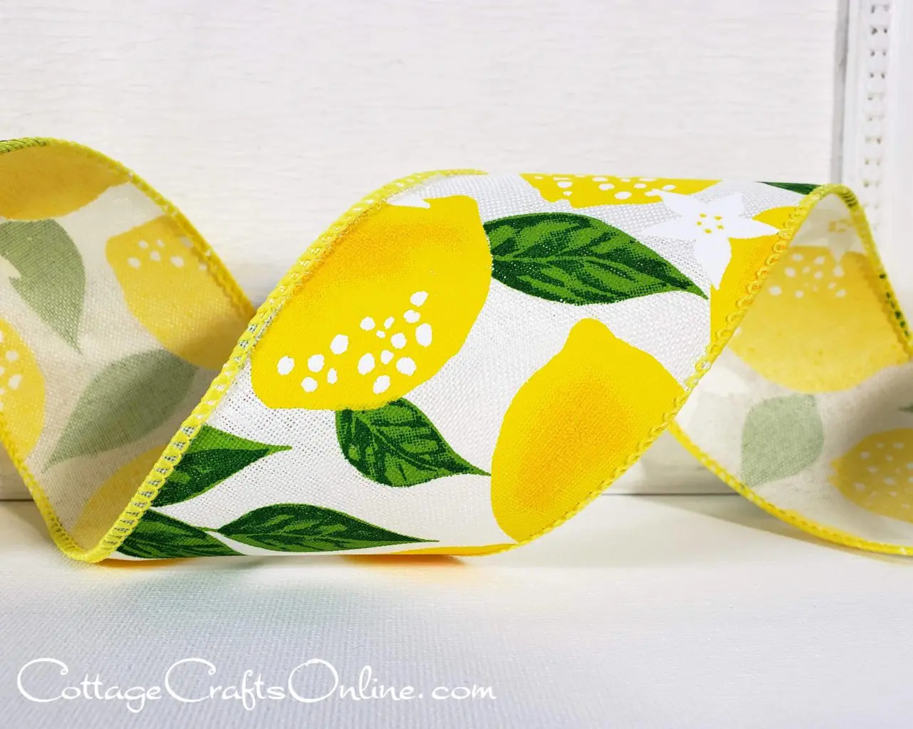 a ribbon with lemons and leaves on it.