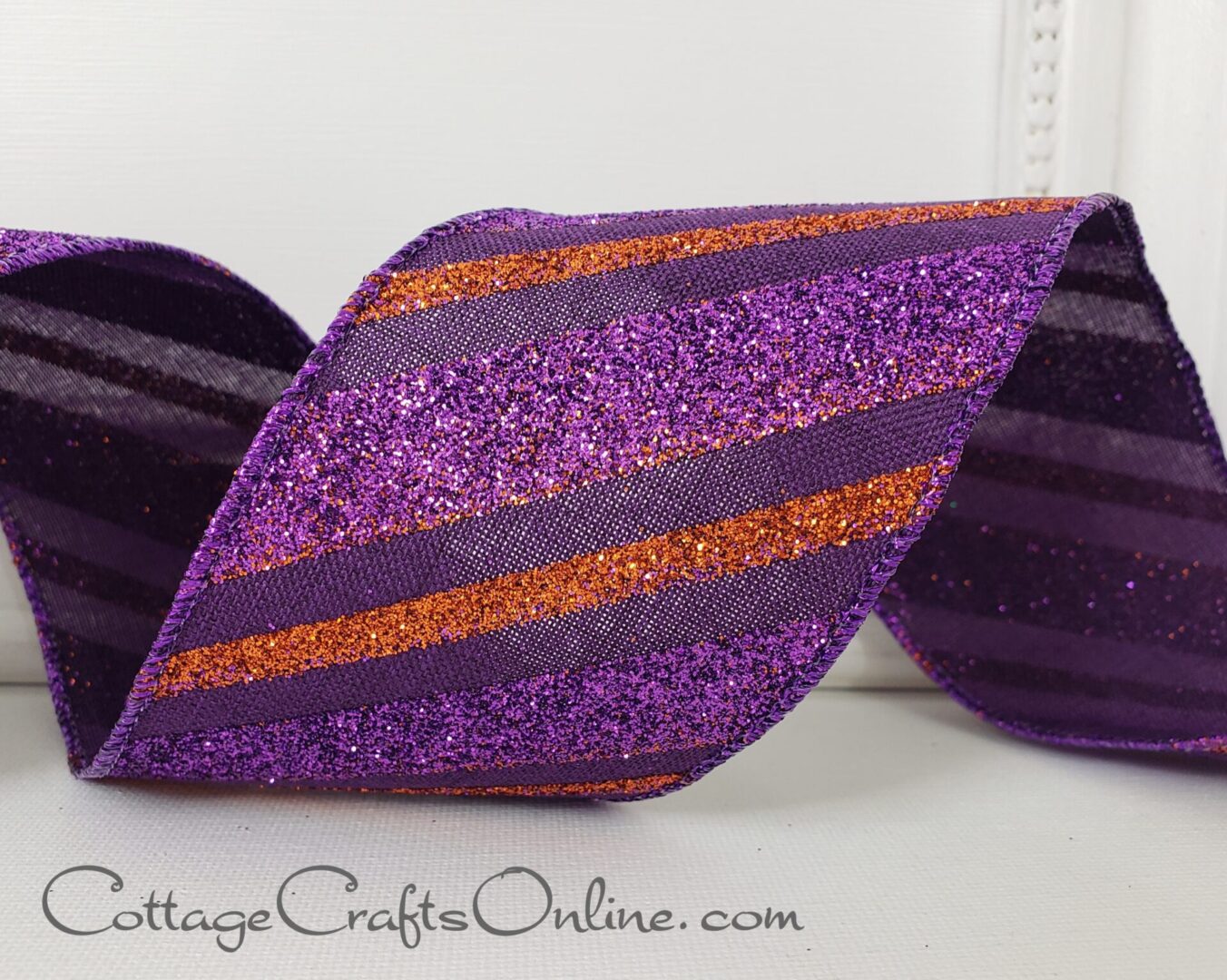 Diagonal stripes purple and orange glitter purple mesh 2.5" wide wired ribbon from the Etsy shop of Cottage Crafts Online.