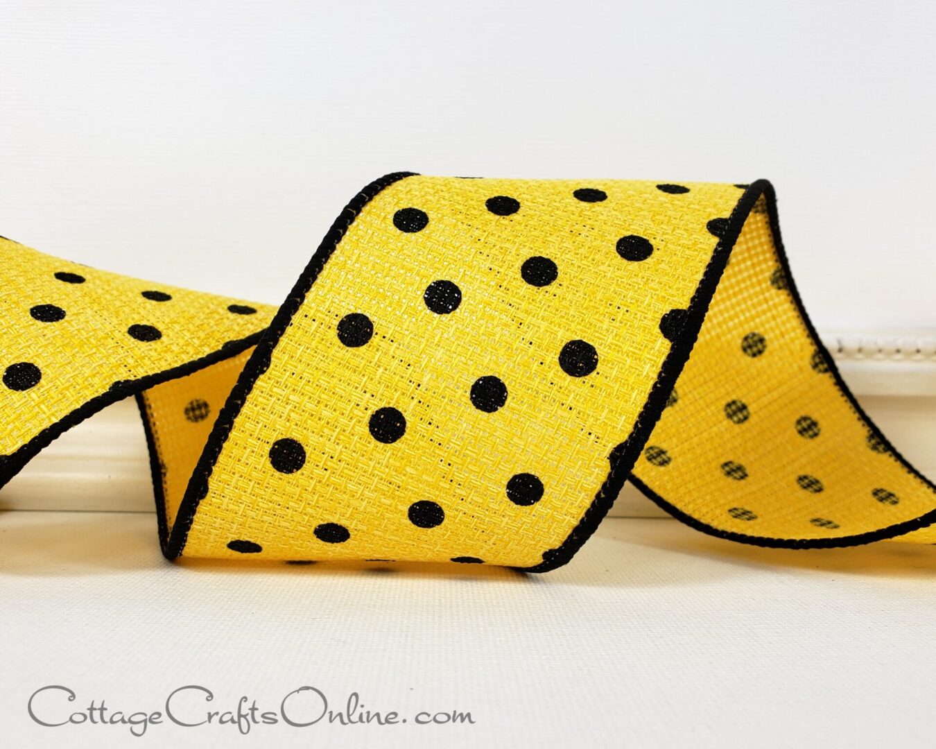 Small black dots on yellow open weave with black edge 2.5" wide wired ribbon from the Etsy shop of Cottage Crafts Online.
