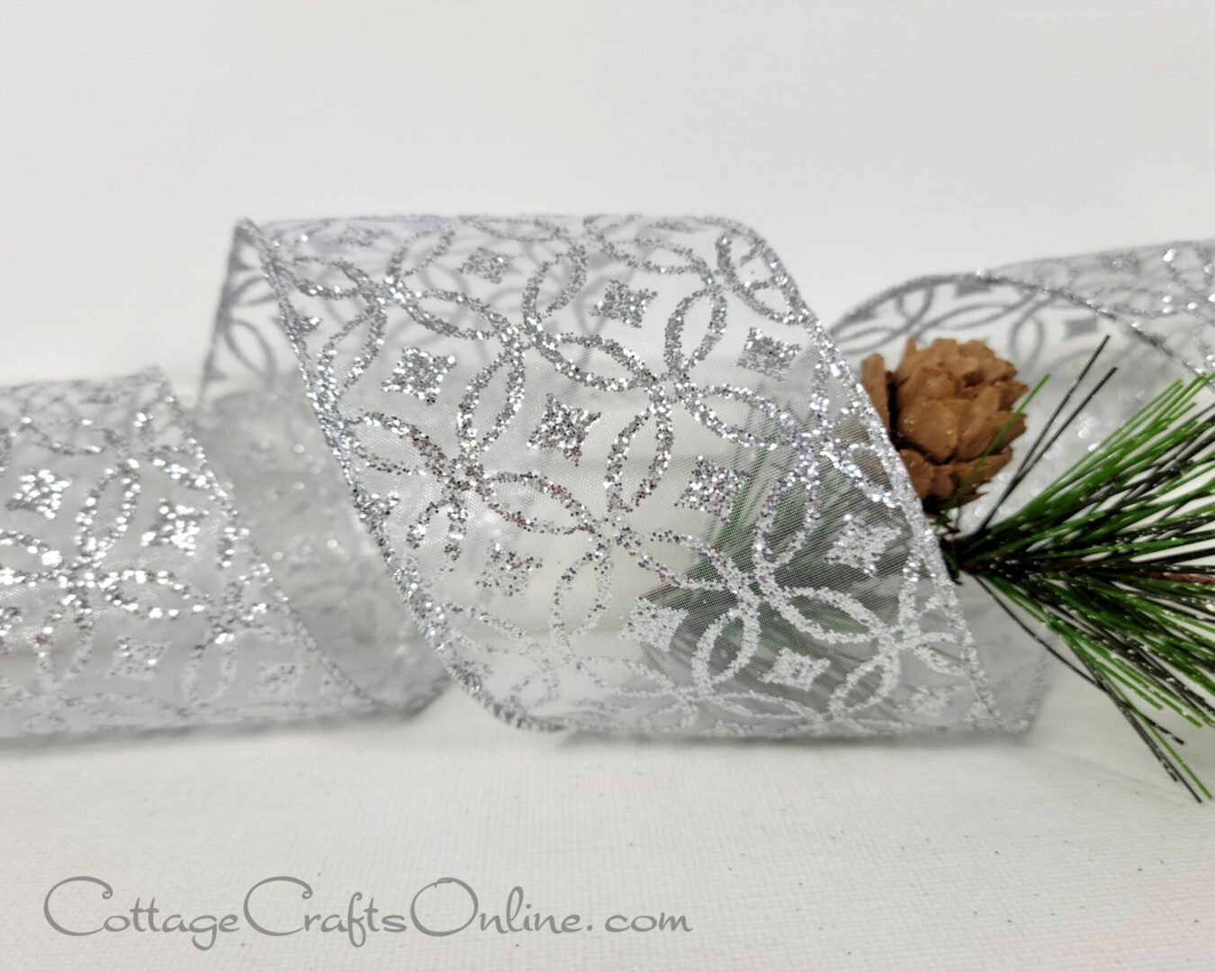 Silver glitter designs on white sheer 2.5" wide wired ribbon from the Etsy shop of Cottage Crafts Online.