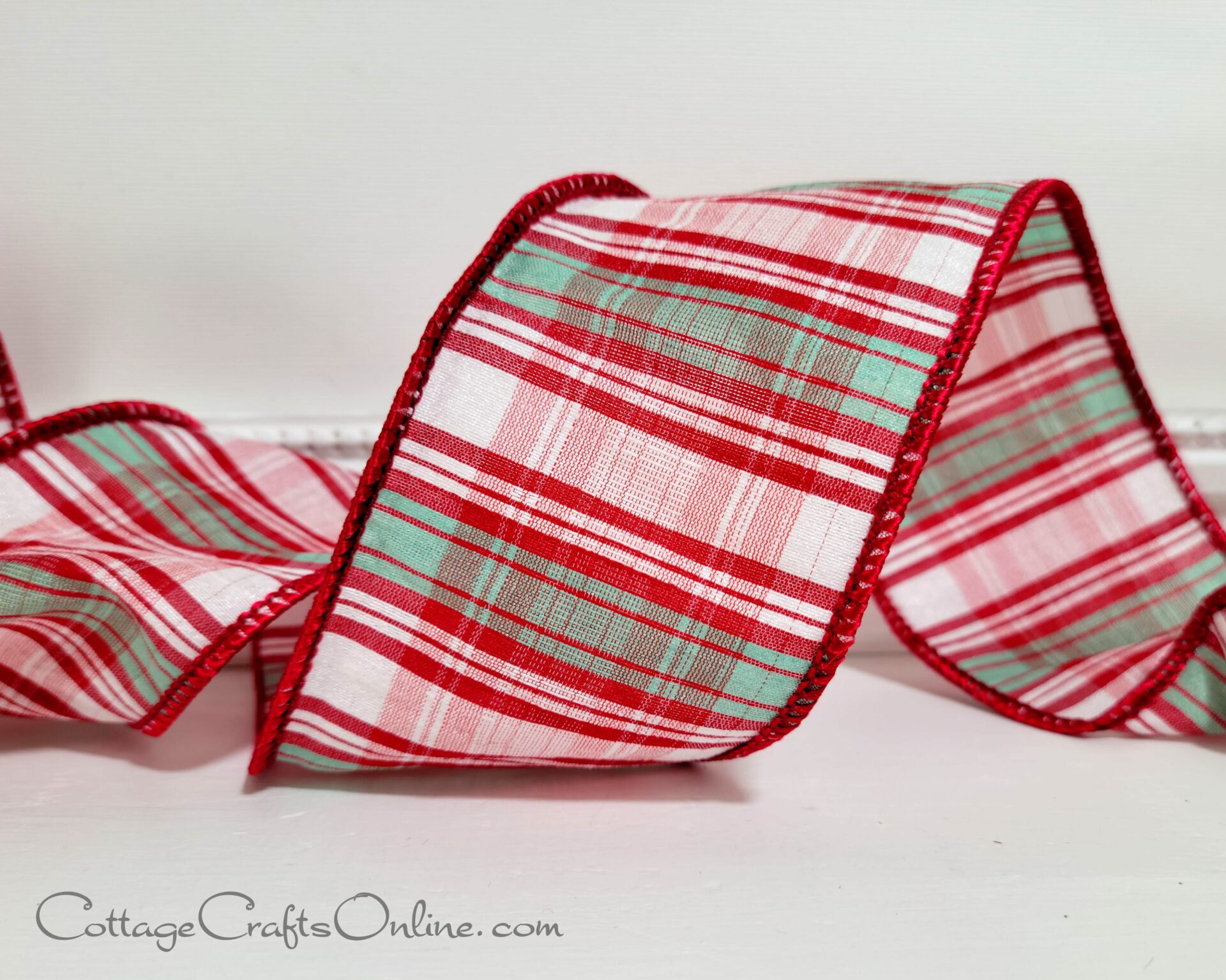 a fall-themed ribbon featuring red plaid on a white surface.