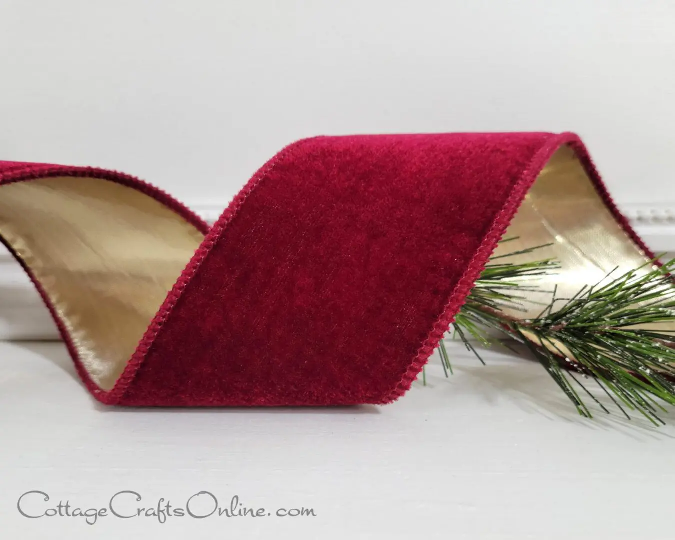 a burgundy velvet ribbon on a white table, perfect for t2022 holiday decor.
