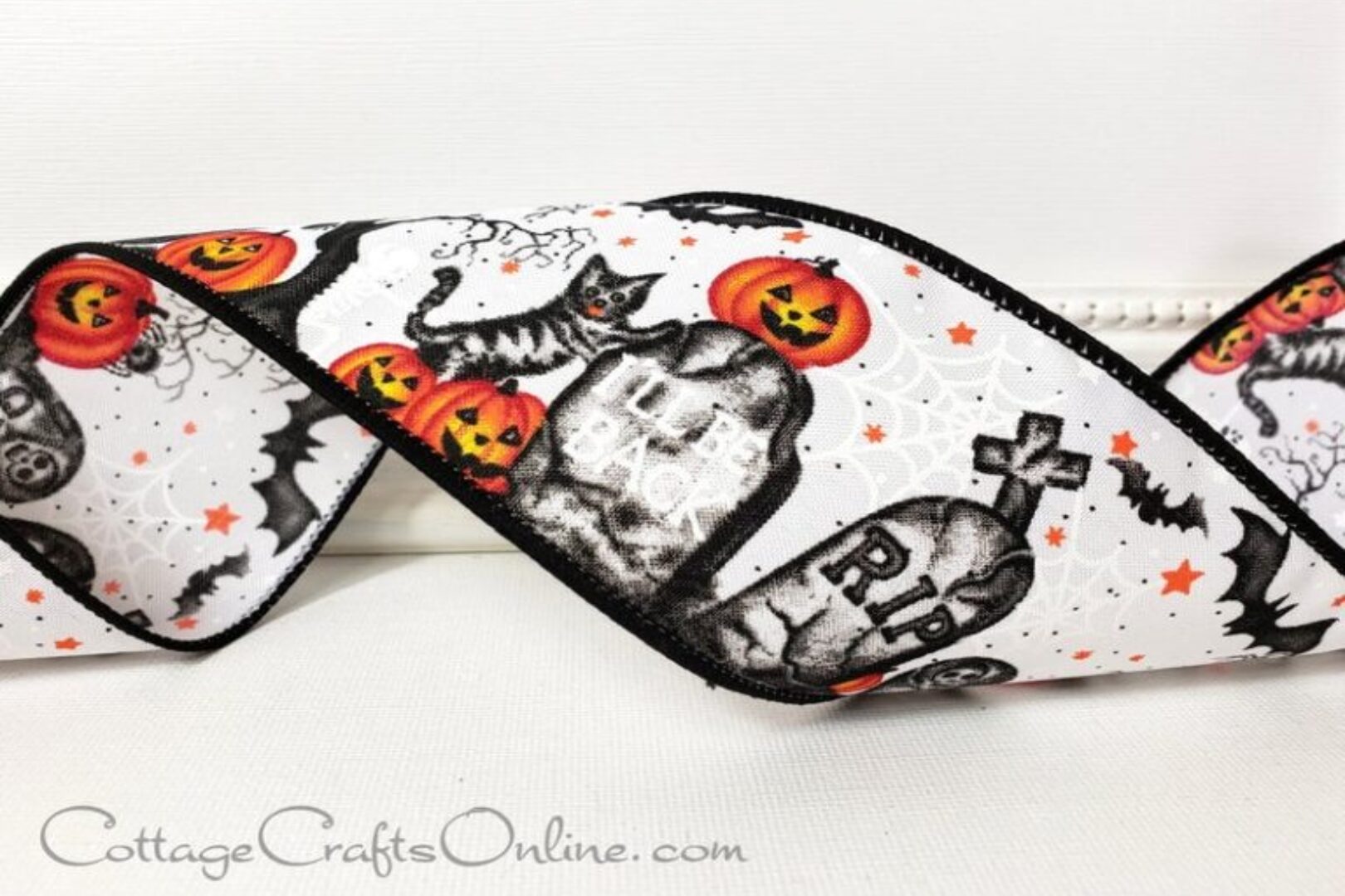 a black and white halloween ribbon with pumpkins and ghosts on it.