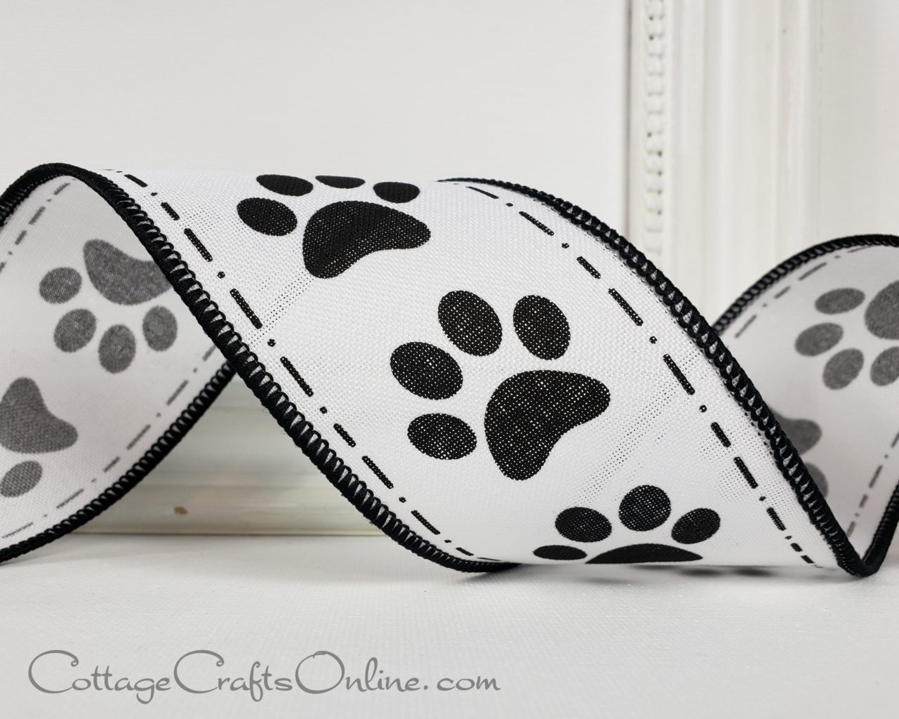 A black and white ribbon with pawprint patterns