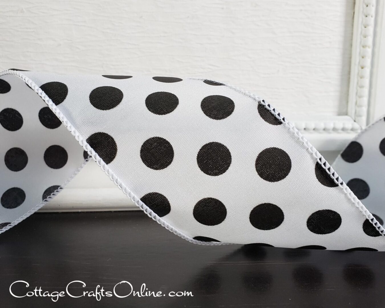 Large black dots on white satin 2.5" wide wired ribbon from the Etsy shop of Cottage Crafts Online.