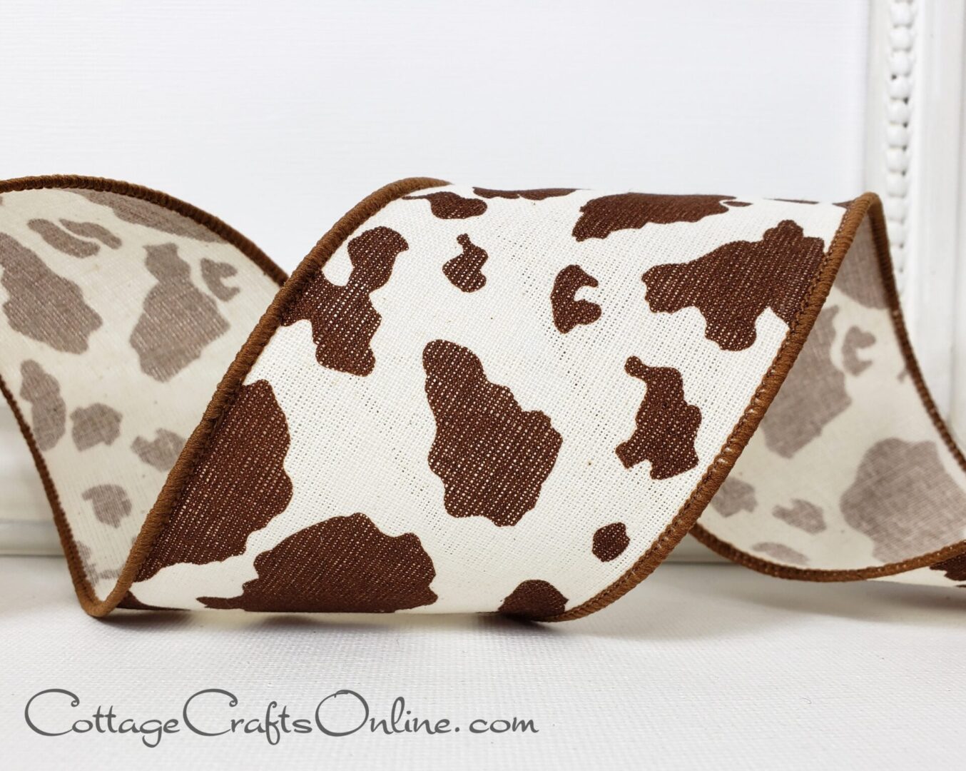 Mocha brown cowhide print on ivory 2.5" wide wired ribbon from the Etsy shop of Cottage Crafts Online.