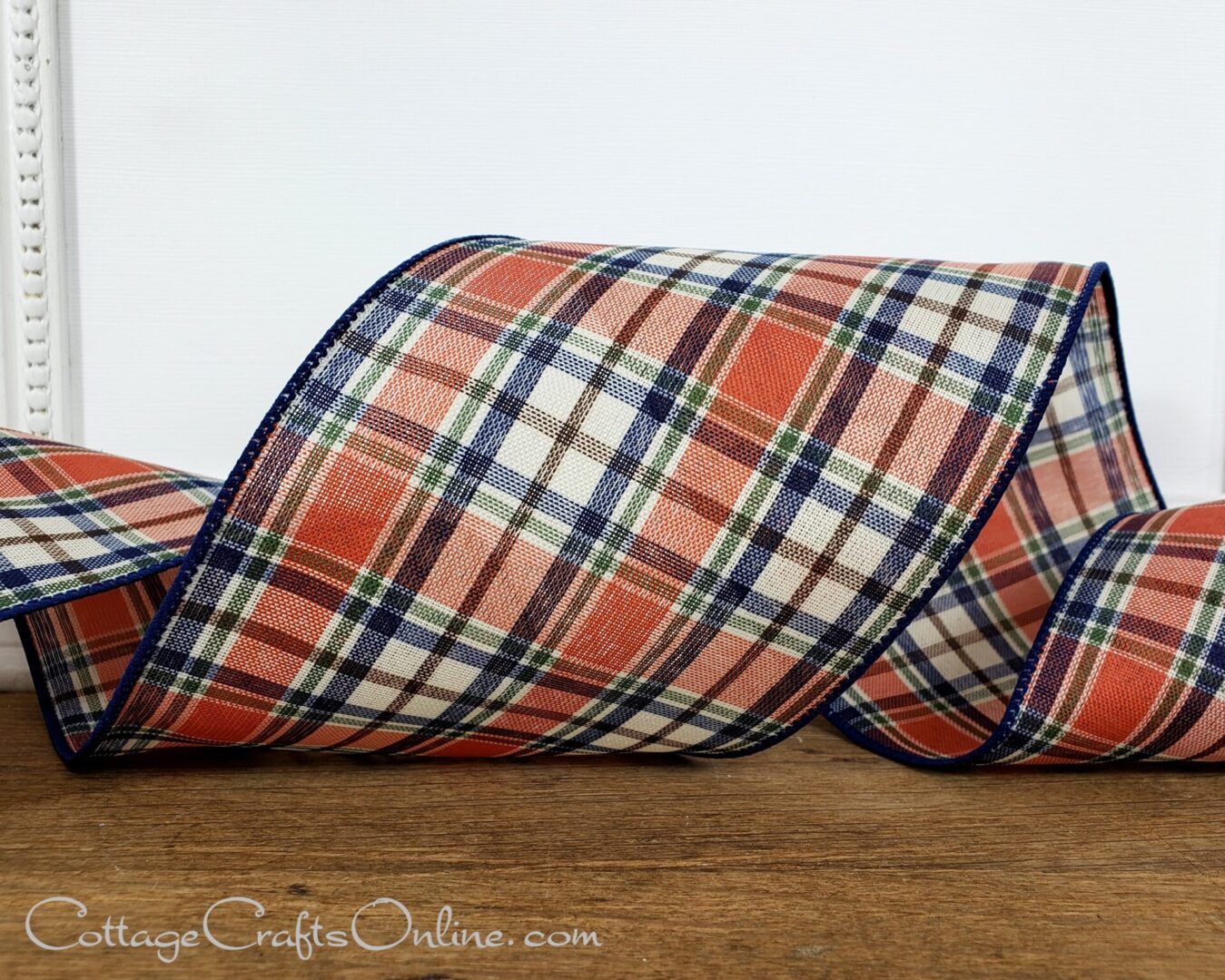 an orange plaid ribbon on a wooden floor from Cottage Crafts Online.