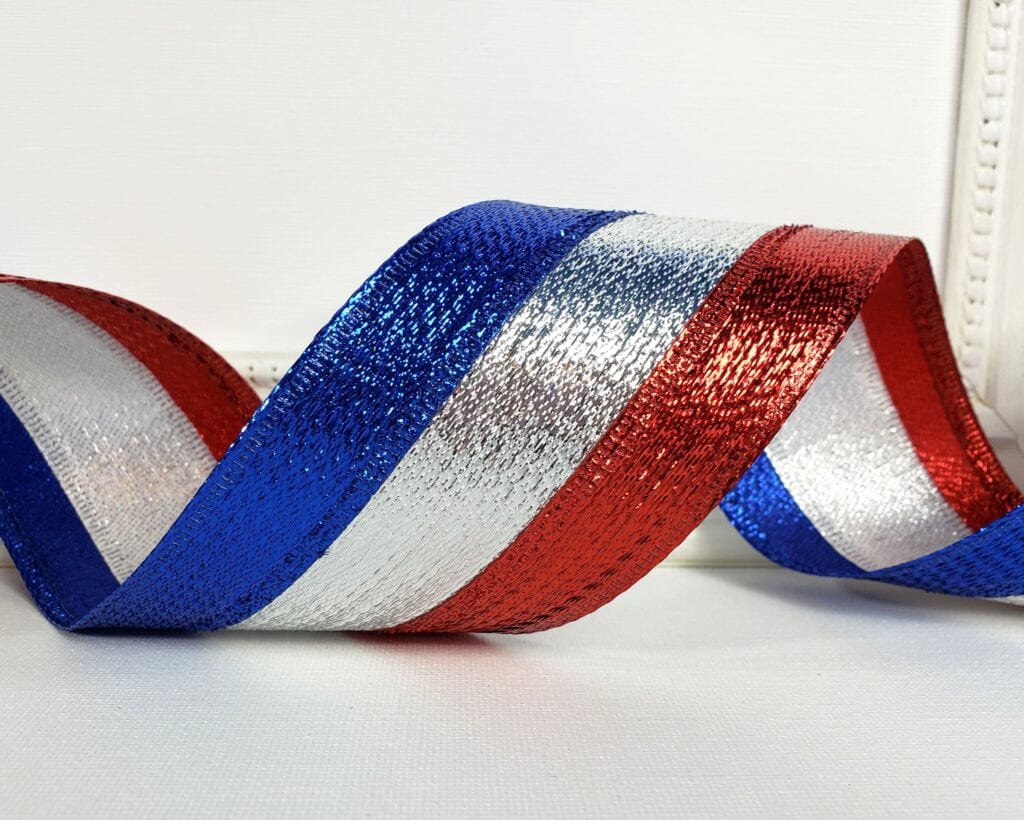 A red white and blue ribbon is curled up