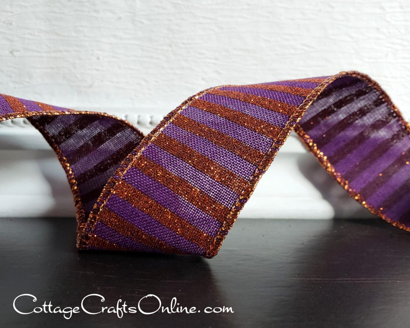 A purple and orange striped ribbon on a table.