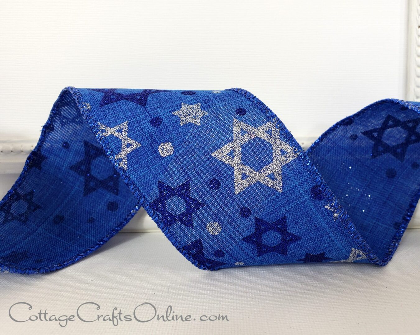 Stars of David dark blue and silver glitter on blue linen 2.5" wide wired ribbon from the Etsy shop of Cottage Crafts Online.