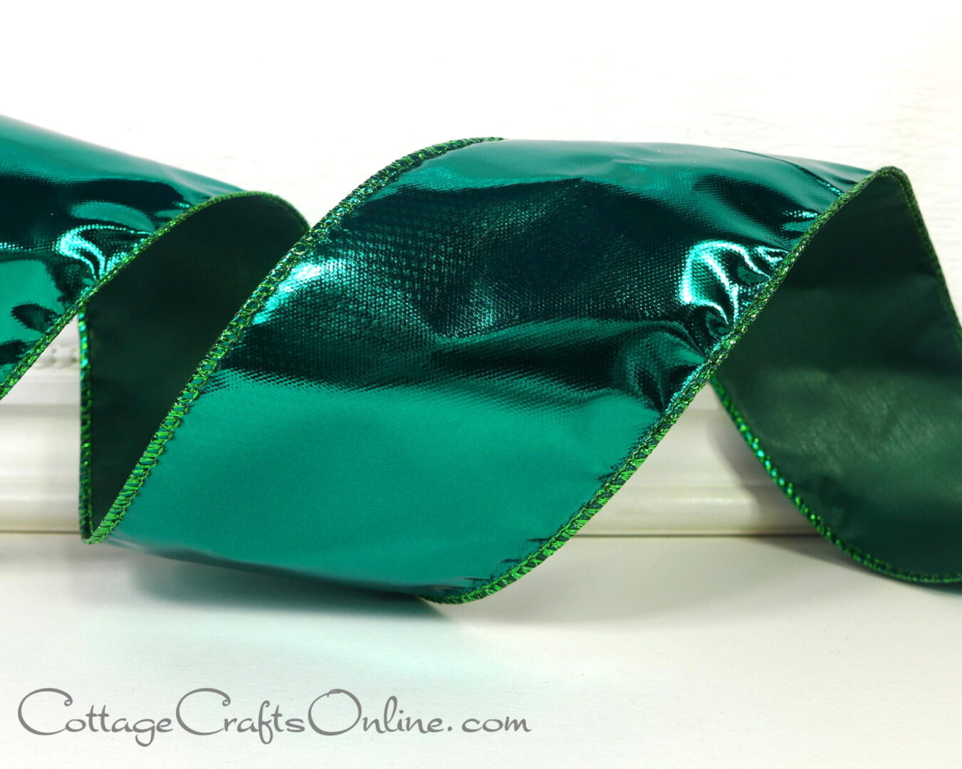 Green ribbon on white surface.