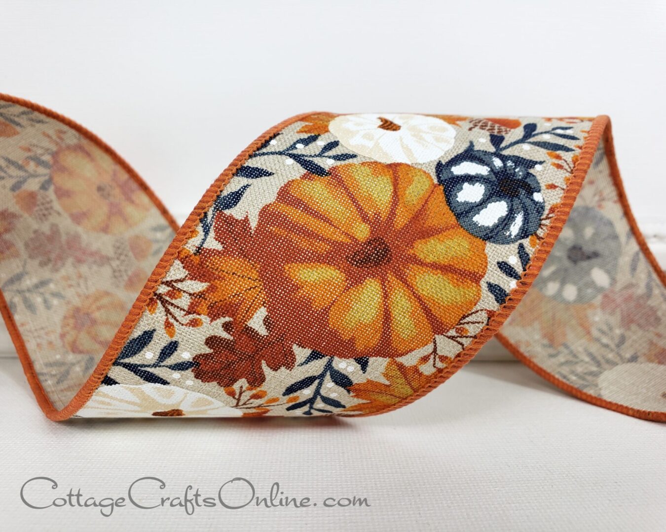 Orange navy white pumpkins and leaves on tan 2.5" wide wired ribbon from the Etsy shop of Cottage Crafts Online.