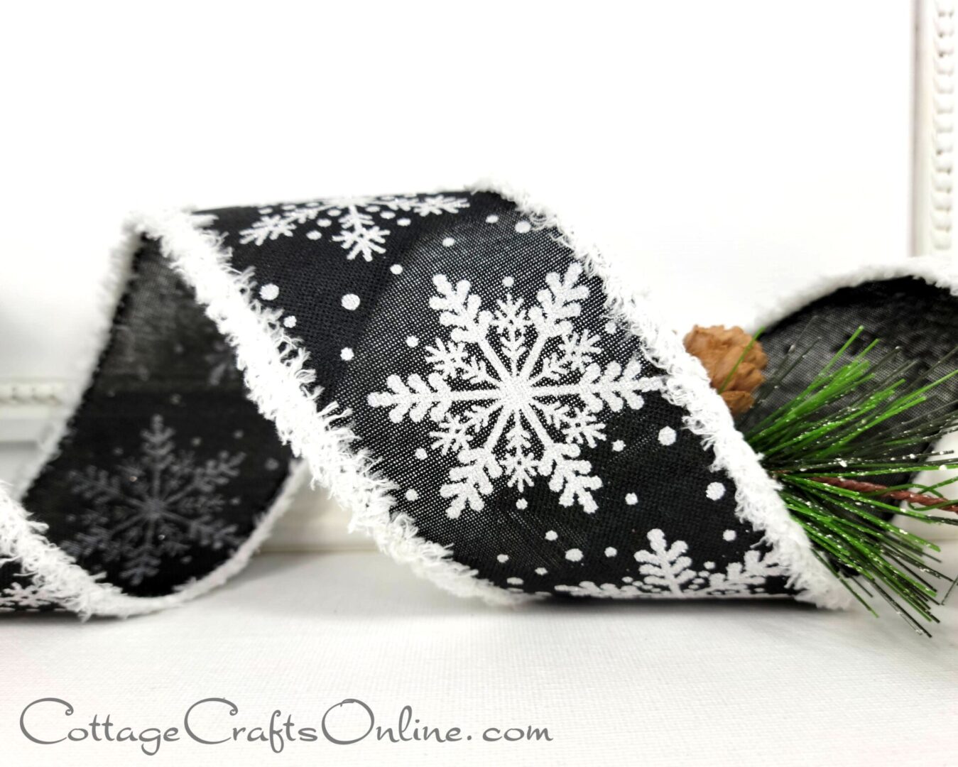 White snowflakes on black with white chenille edge 2.5" wide wired ribbon from the Etsy shop of Cottage Crafts Online.