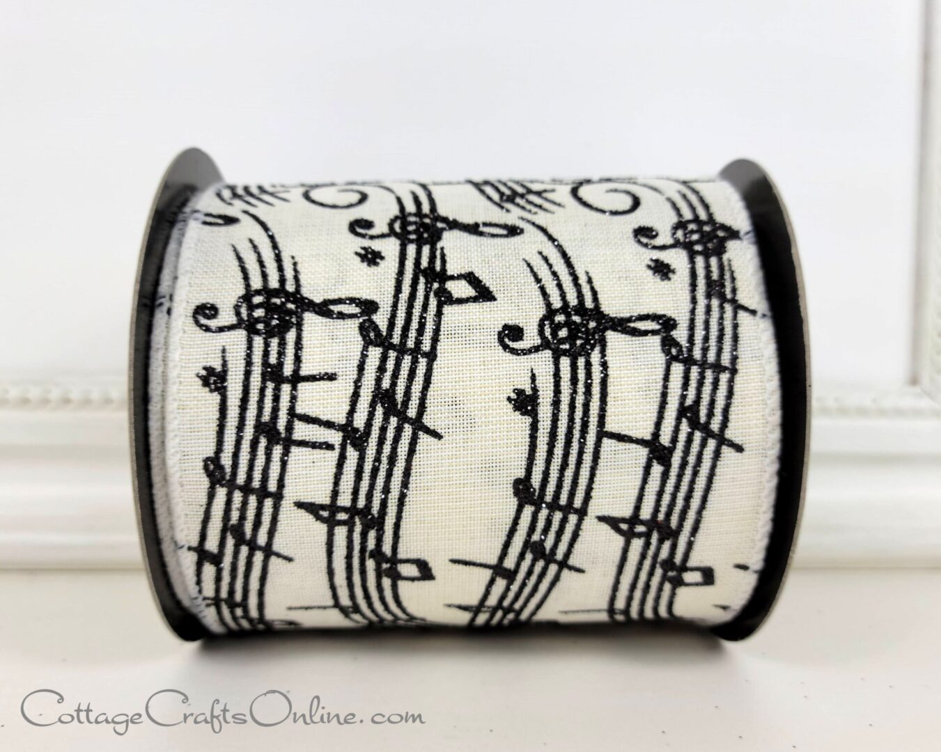 Black glitter music print on ivory 2.5" wired ribbon from the Etsy shop of Cottage Crafts Online.