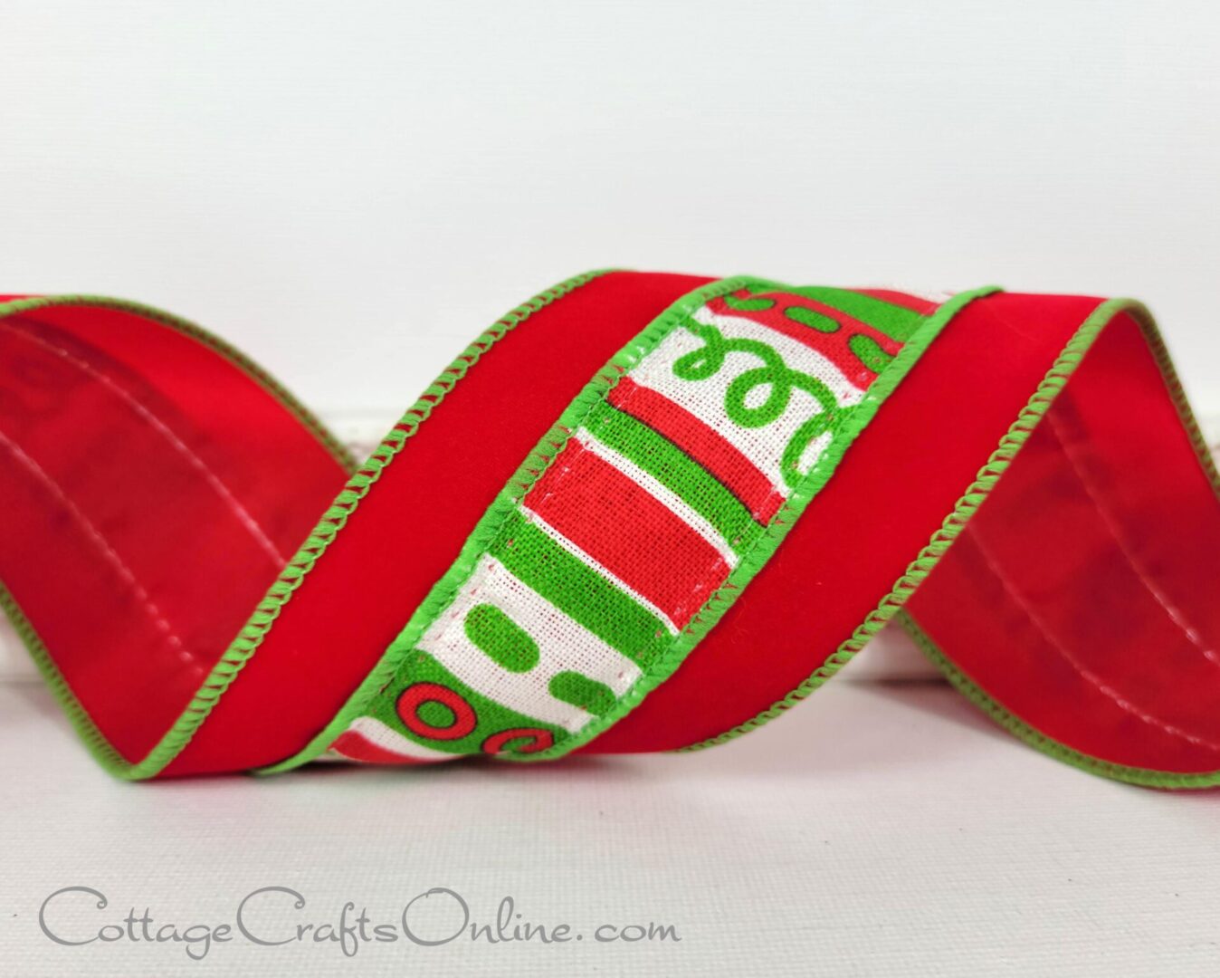 a red and green ribbon with a christmas design.