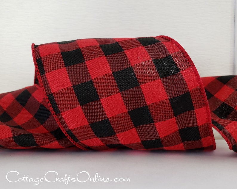 A red and black plaid ribbon is sitting on top of the table.