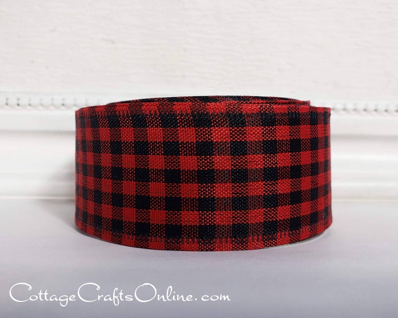 A red and black plaid ribbon sitting on top of a table.