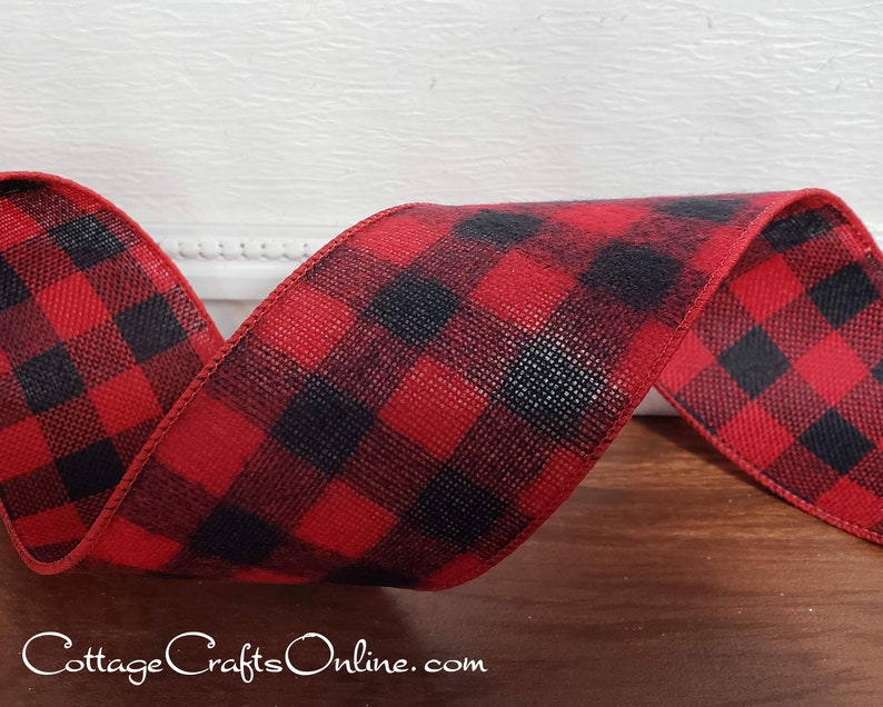 A red and black plaid ribbon sitting on top of a table.