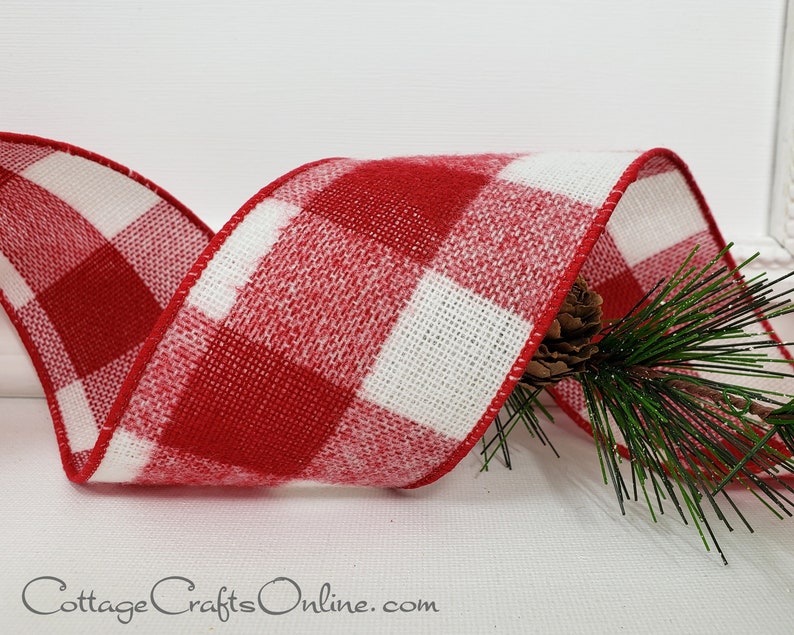 A red and white plaid ribbon with pine needles.