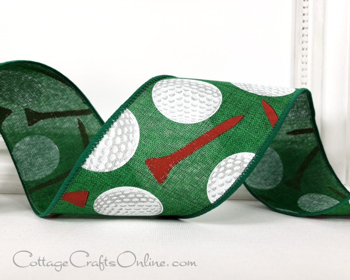 A close up of a ribbon with golf balls and tees