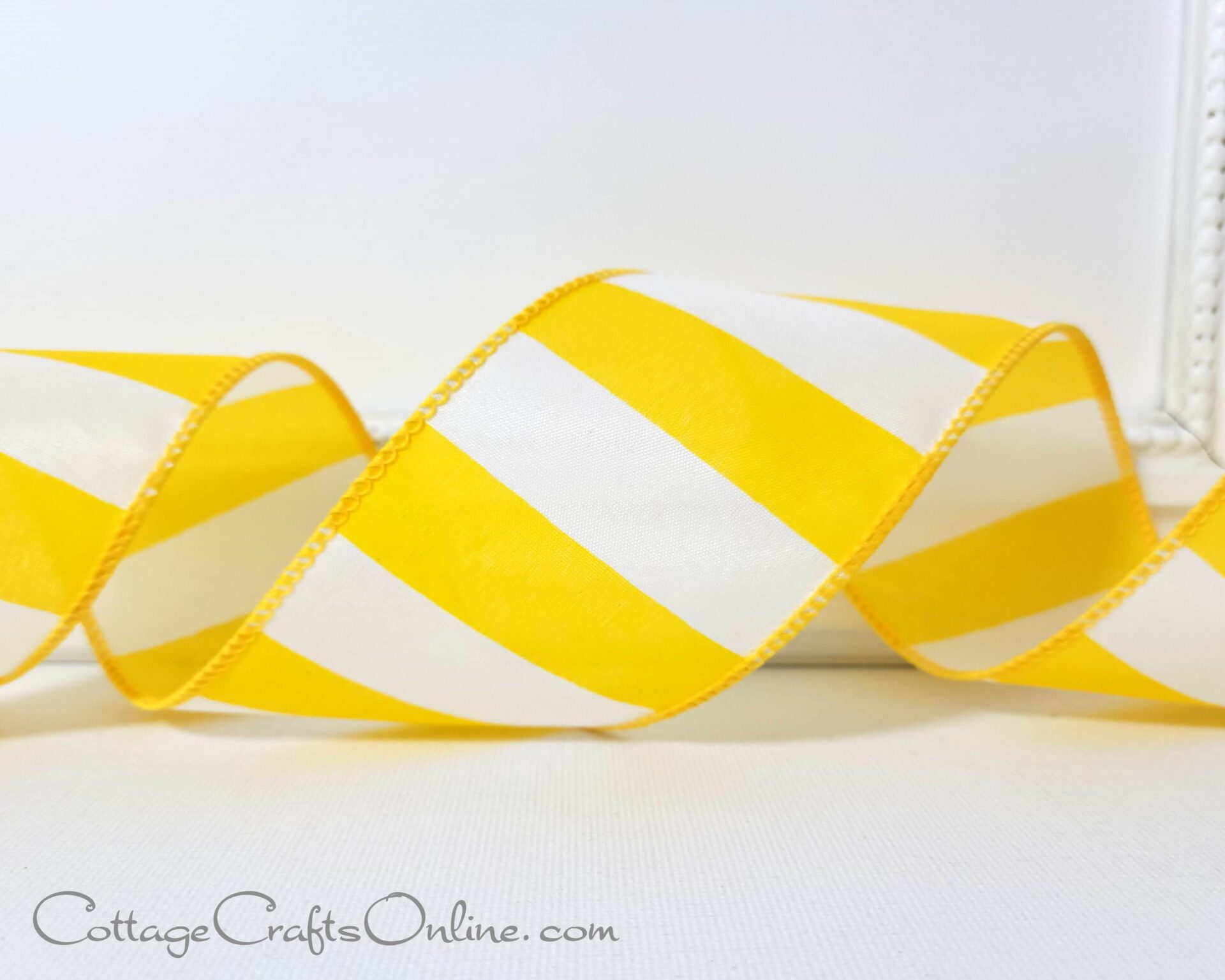 A yellow and white striped ribbon on a table.