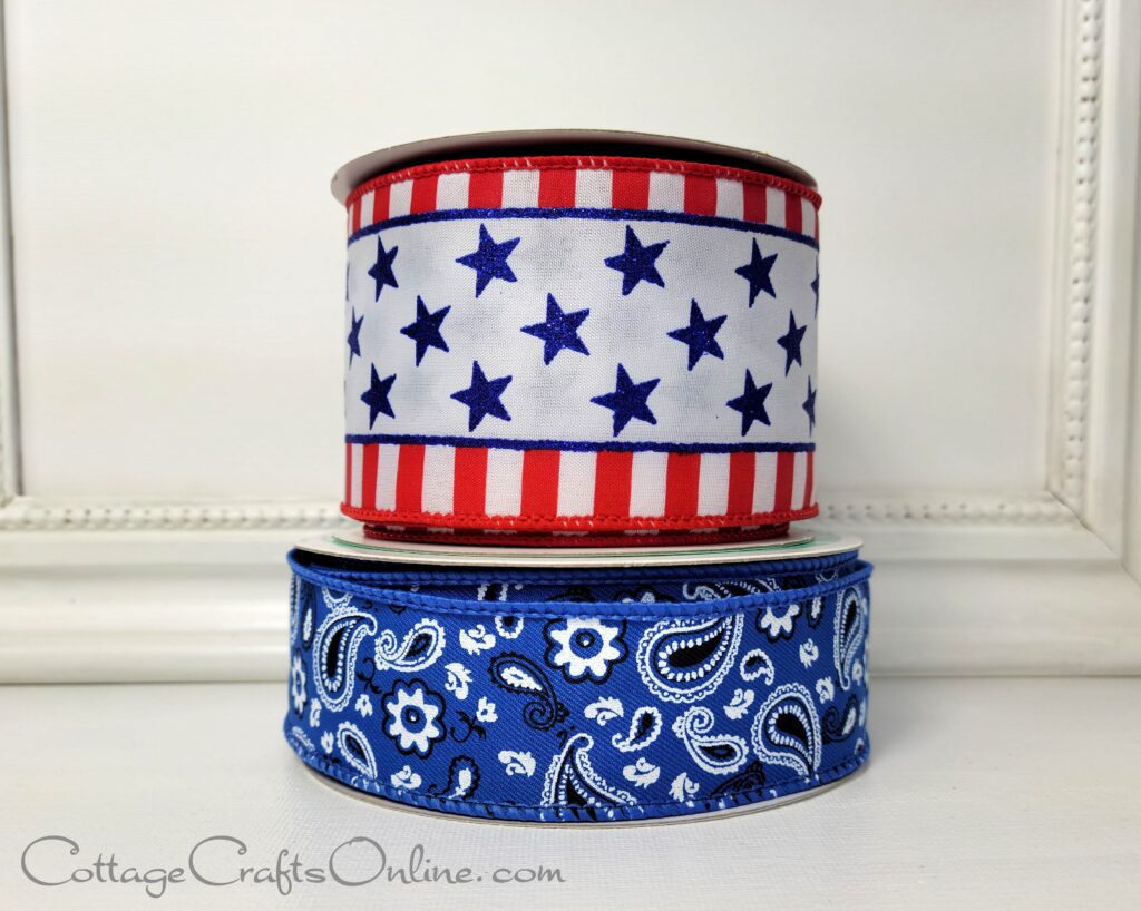 Two rolls of ribbon with stars and stripes on them.