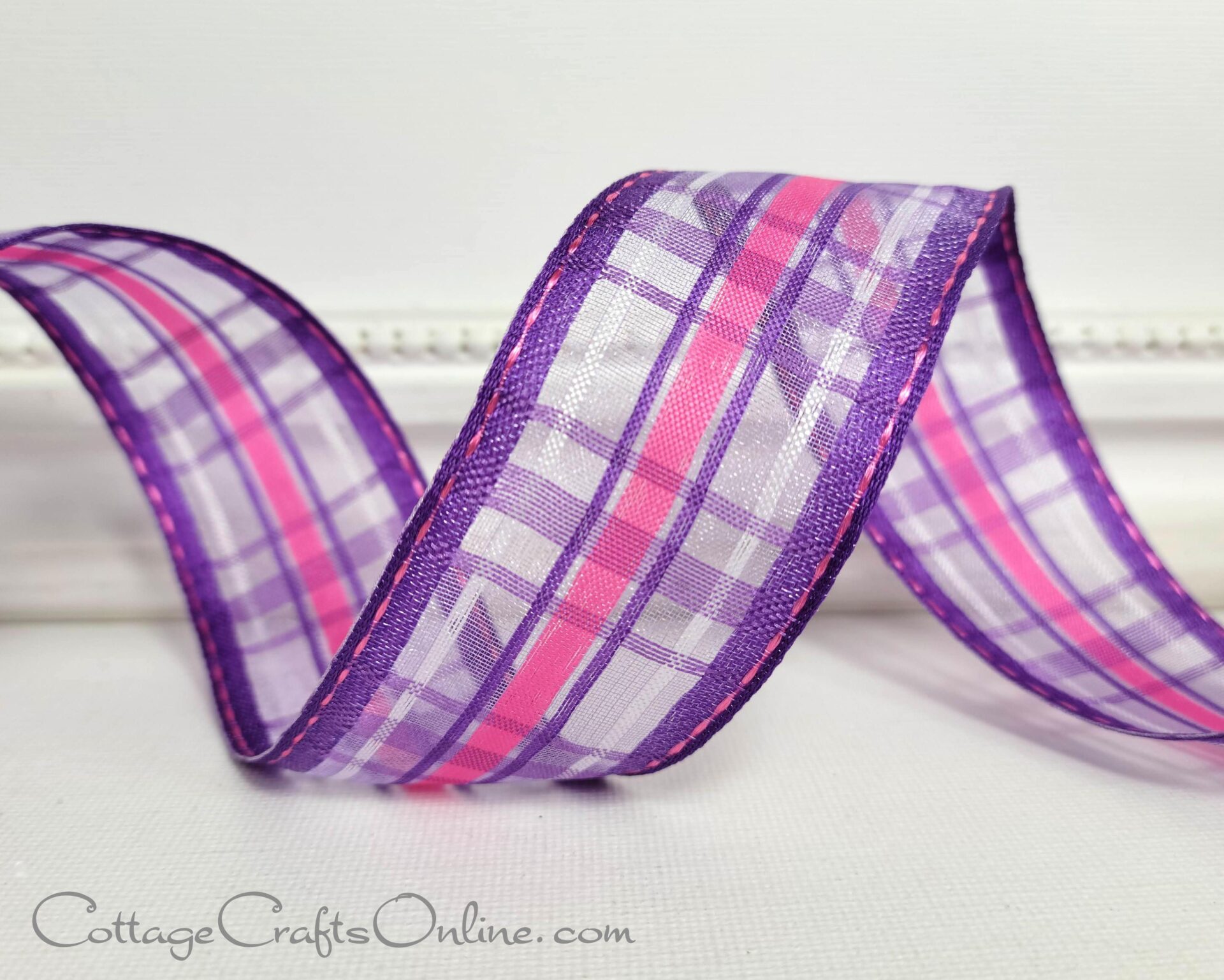 A purple and pink plaid ribbon is sitting on top of a table.