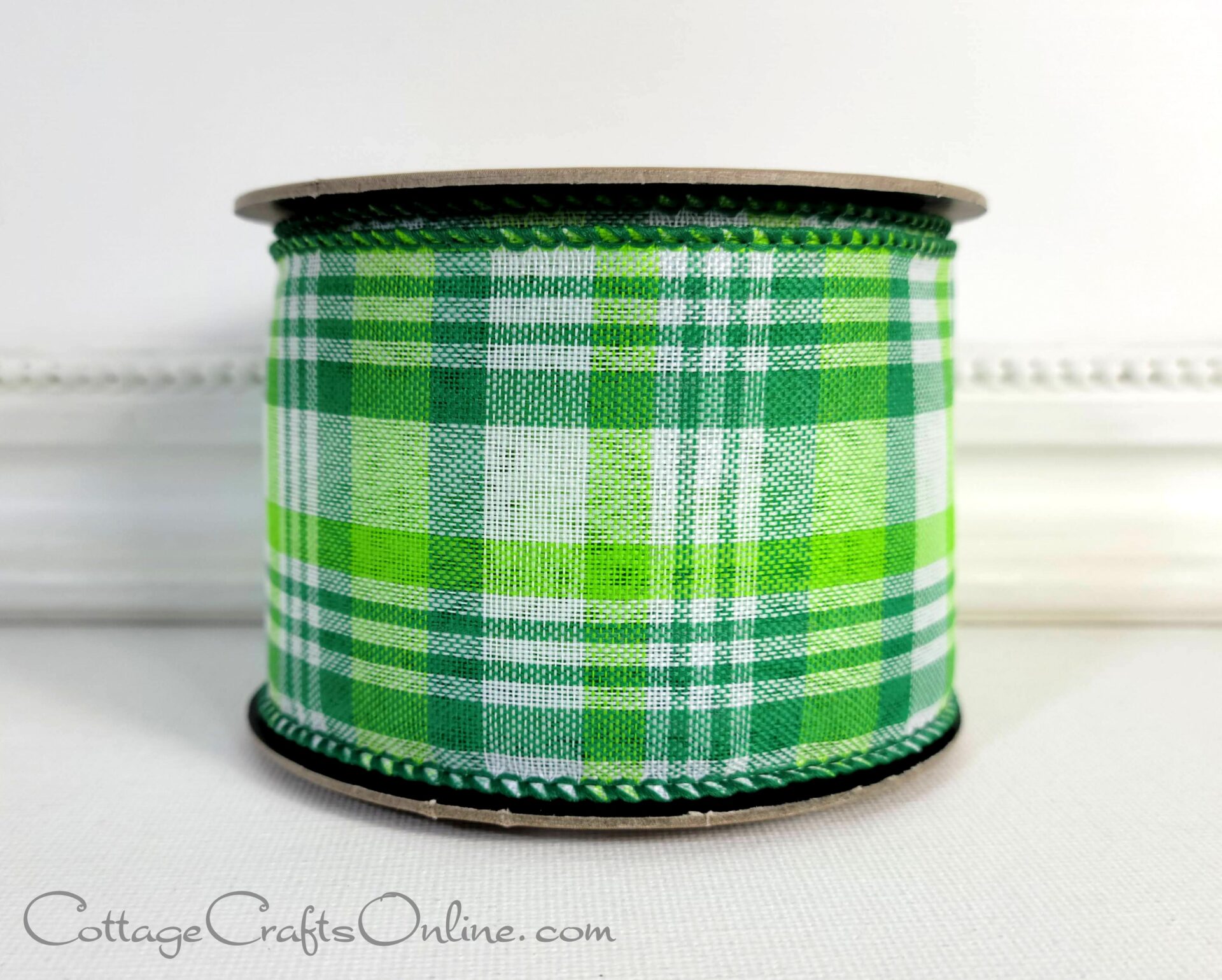 A green plaid ribbon sitting on top of a table.