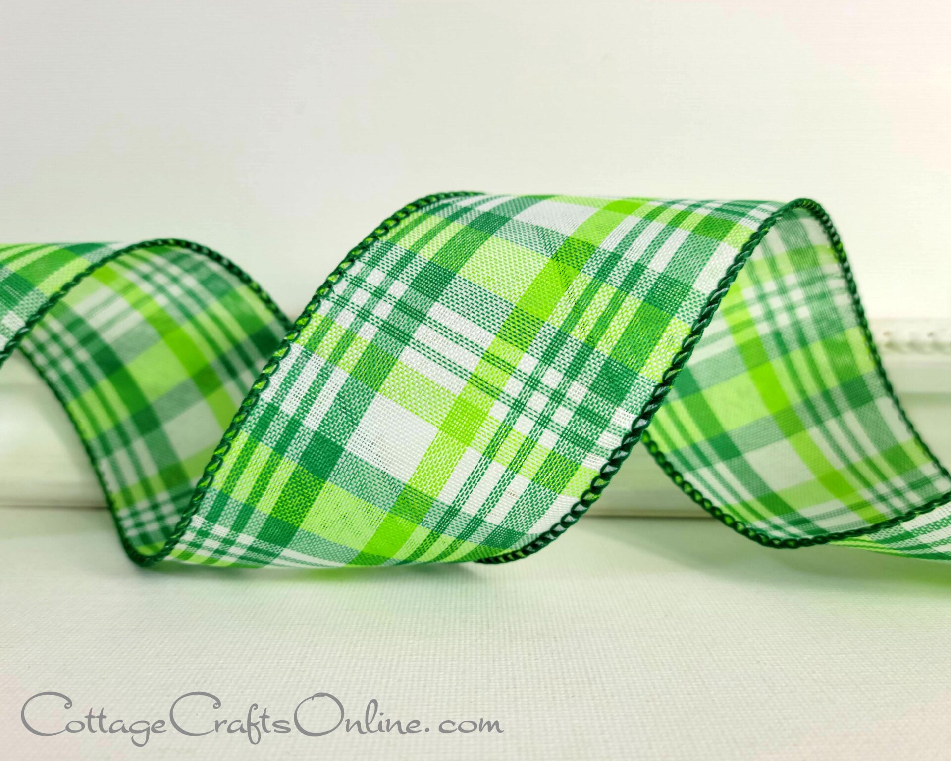 A green plaid ribbon is sitting on top of the table.