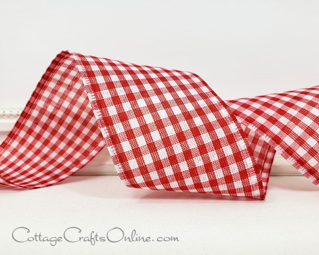 A red and white checkered ribbon sitting on top of a table.
