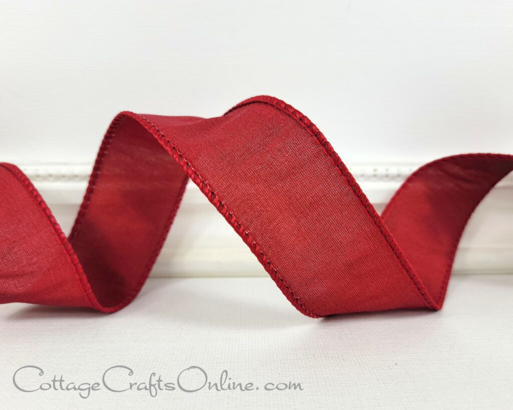 A red ribbon is sitting on top of a table.