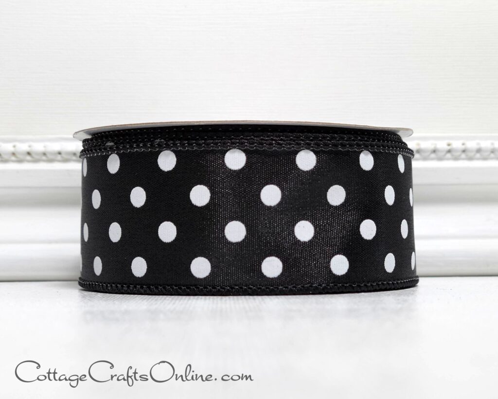 A black and white polka dot ribbon sitting on top of a table.