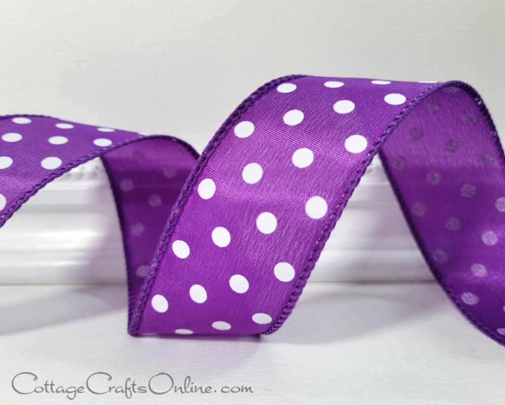 A purple ribbon with white polka dots on it.