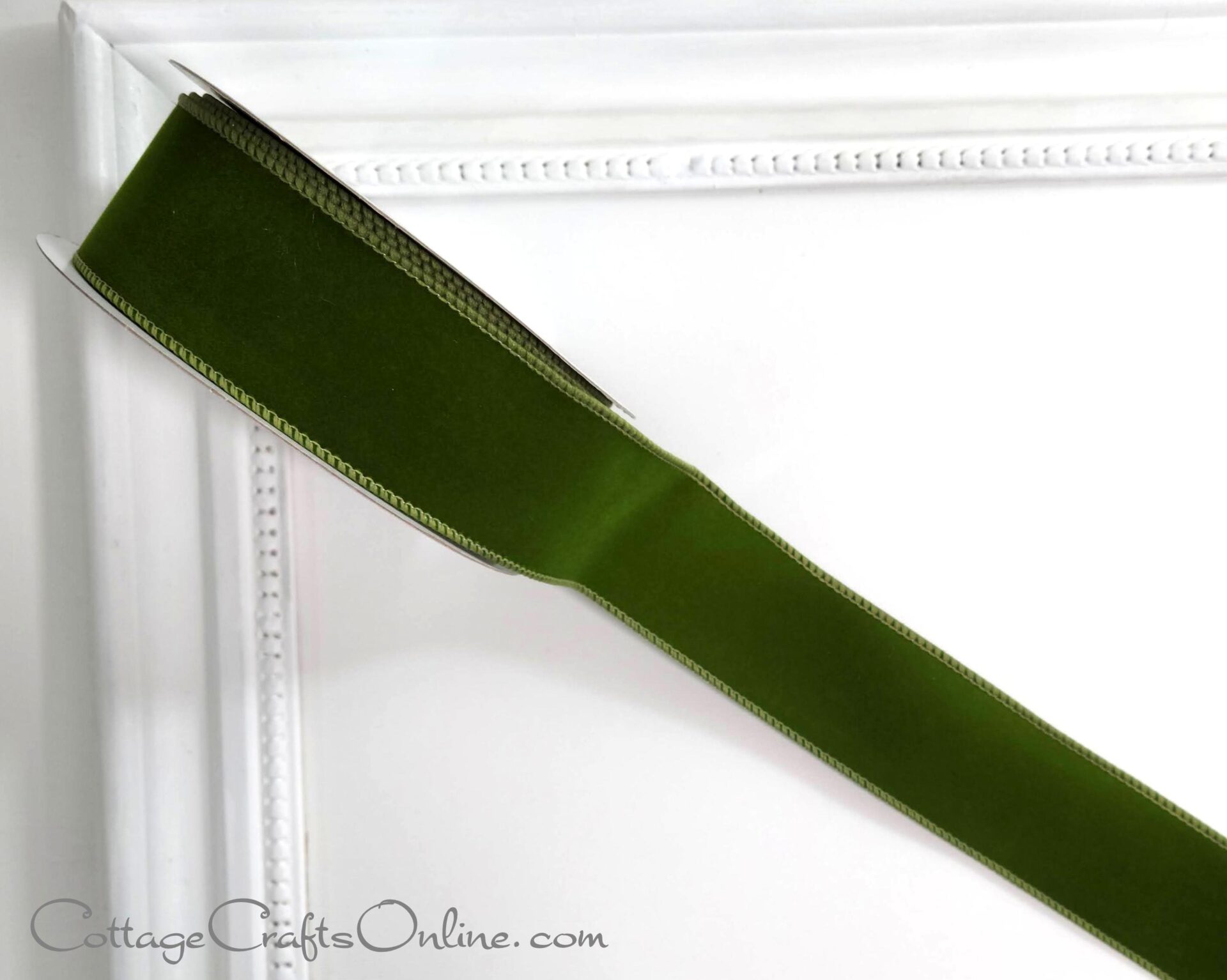 green velvet ribbon on a white frame.