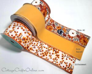 A group of three rolls of ribbon with different designs on them.