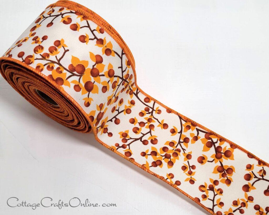 A roll of ribbon with orange and brown flowers on it.