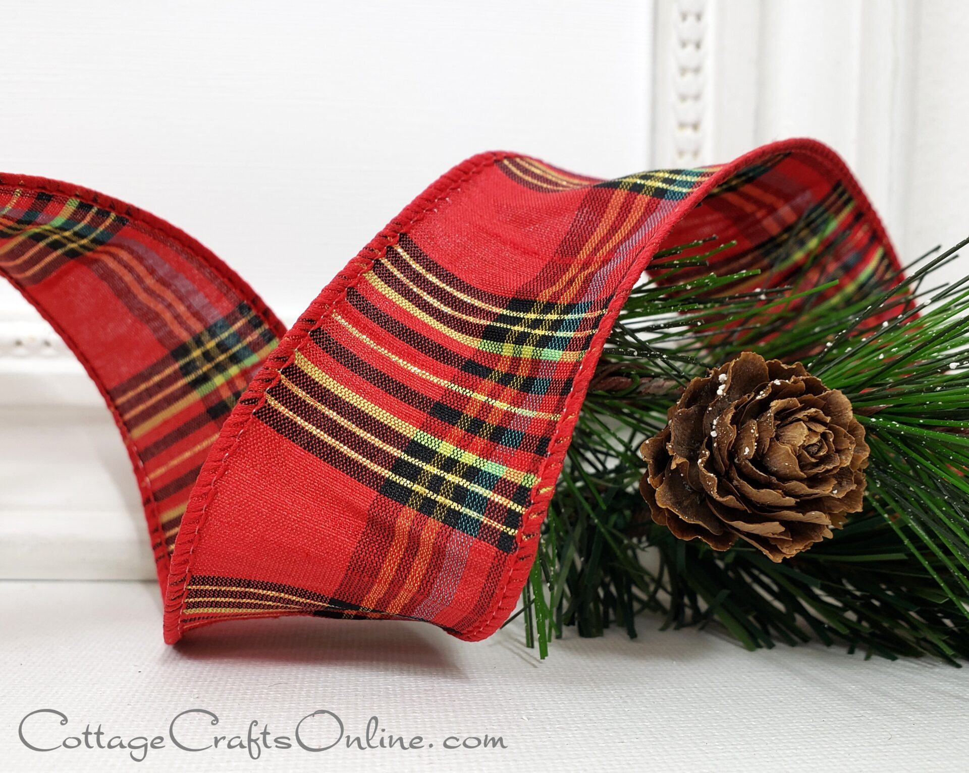 A new plaid ribbon featuring red and pine cones.