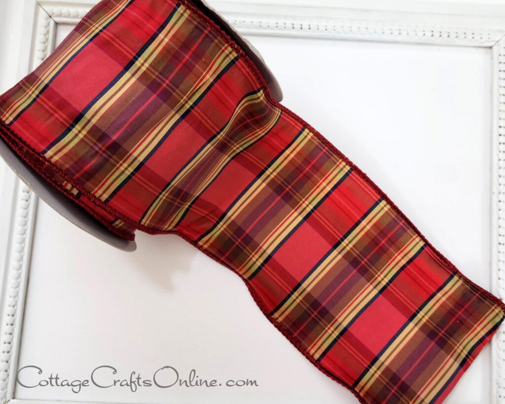 A red plaid ribbon sitting on top of a table.