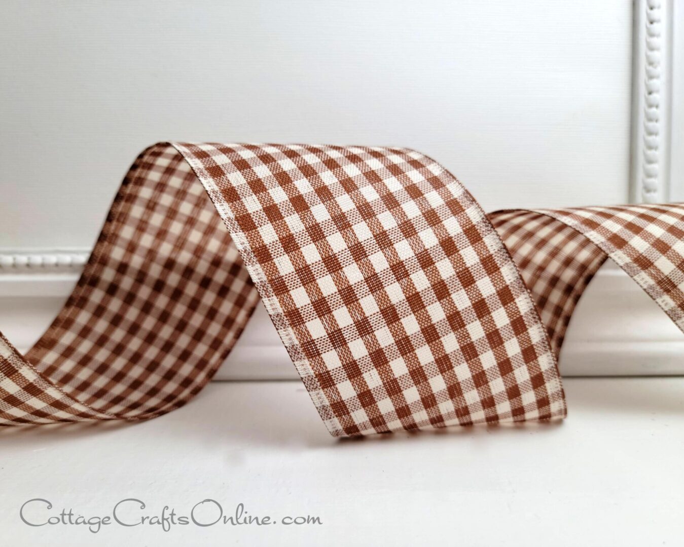 A brown and white checkered ribbon sitting on top of a table.
