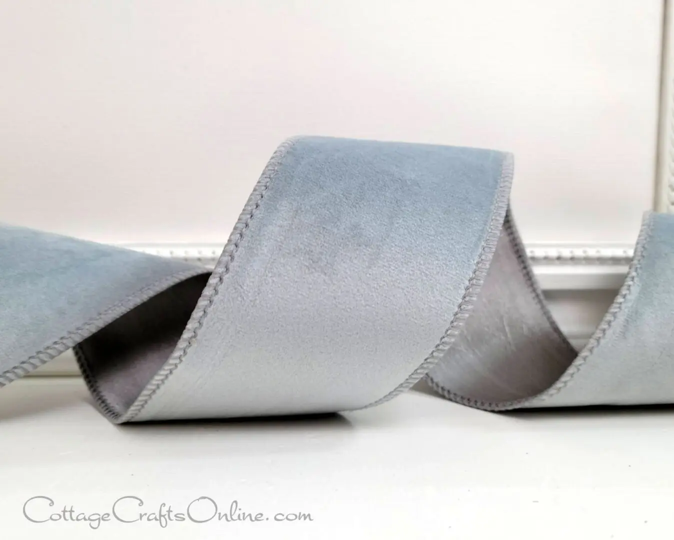 A close up of the ribbon on a silver colored ribbon