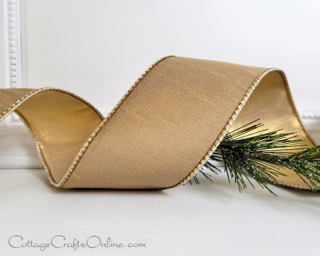 A close up of a ribbon with pine needles