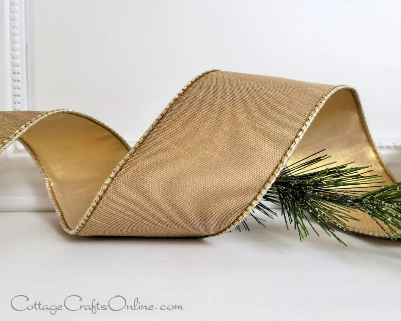 A close up of a ribbon with pine needles