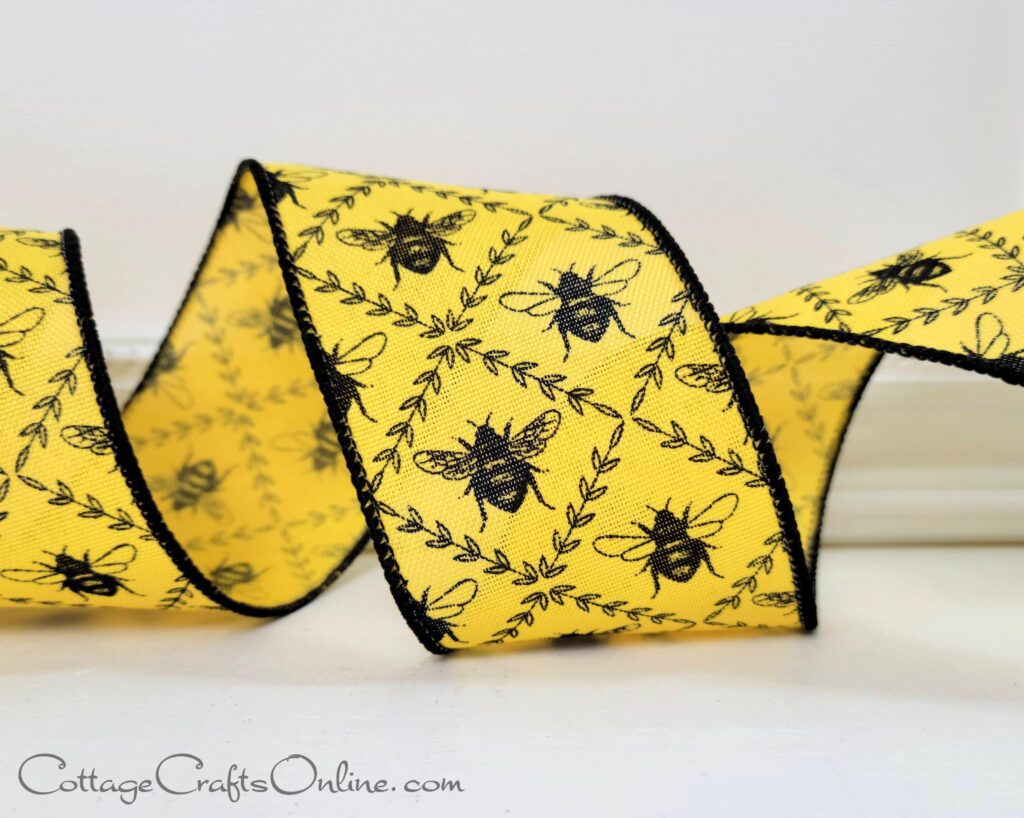 A yellow ribbon with black bees on it.