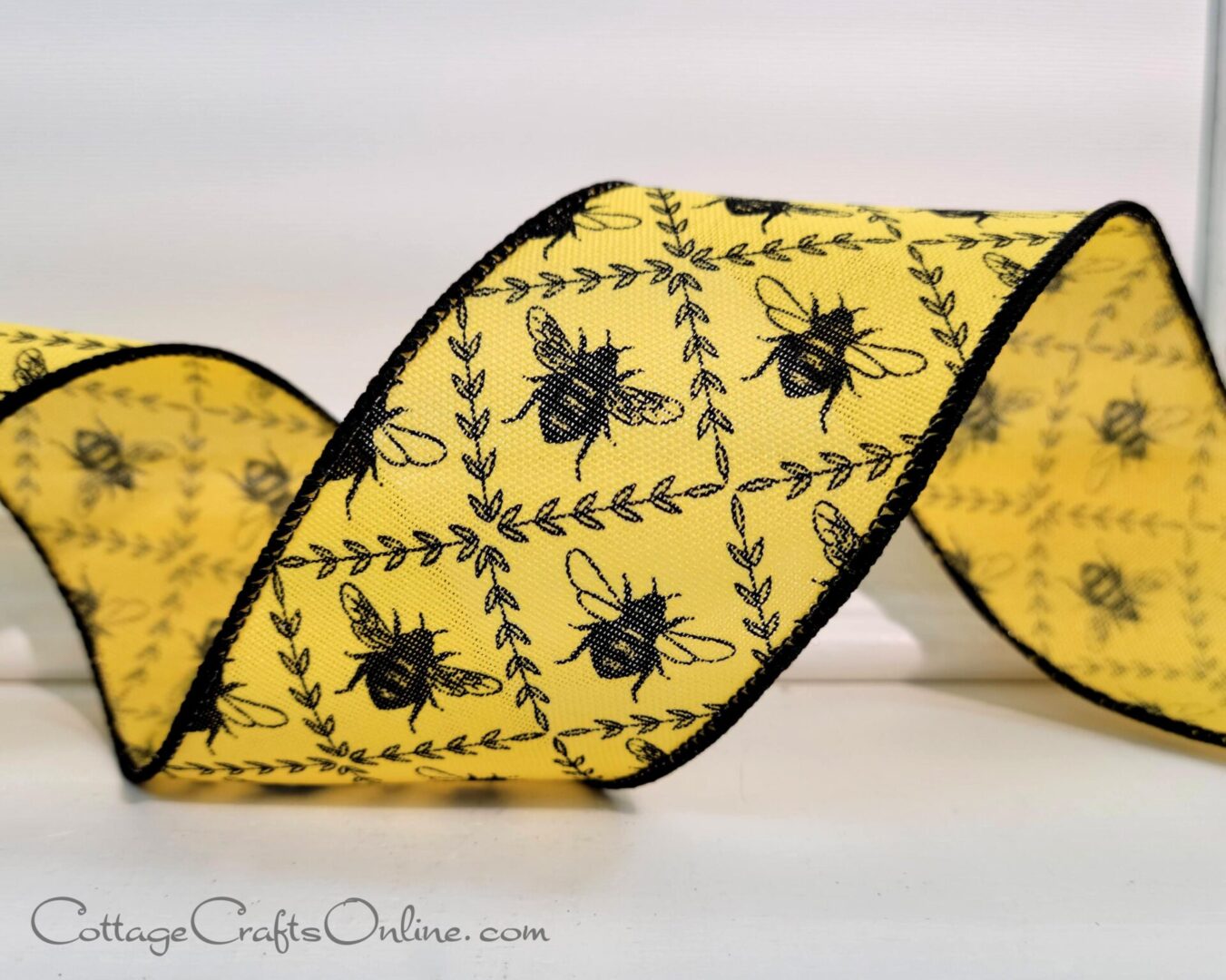 A new holiday ribbon with yellow coloring and a bee design.