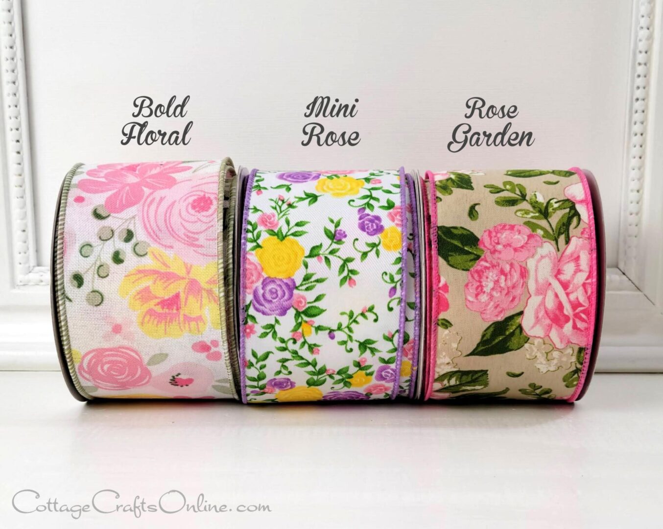 A group of three rolls of ribbon with different designs.