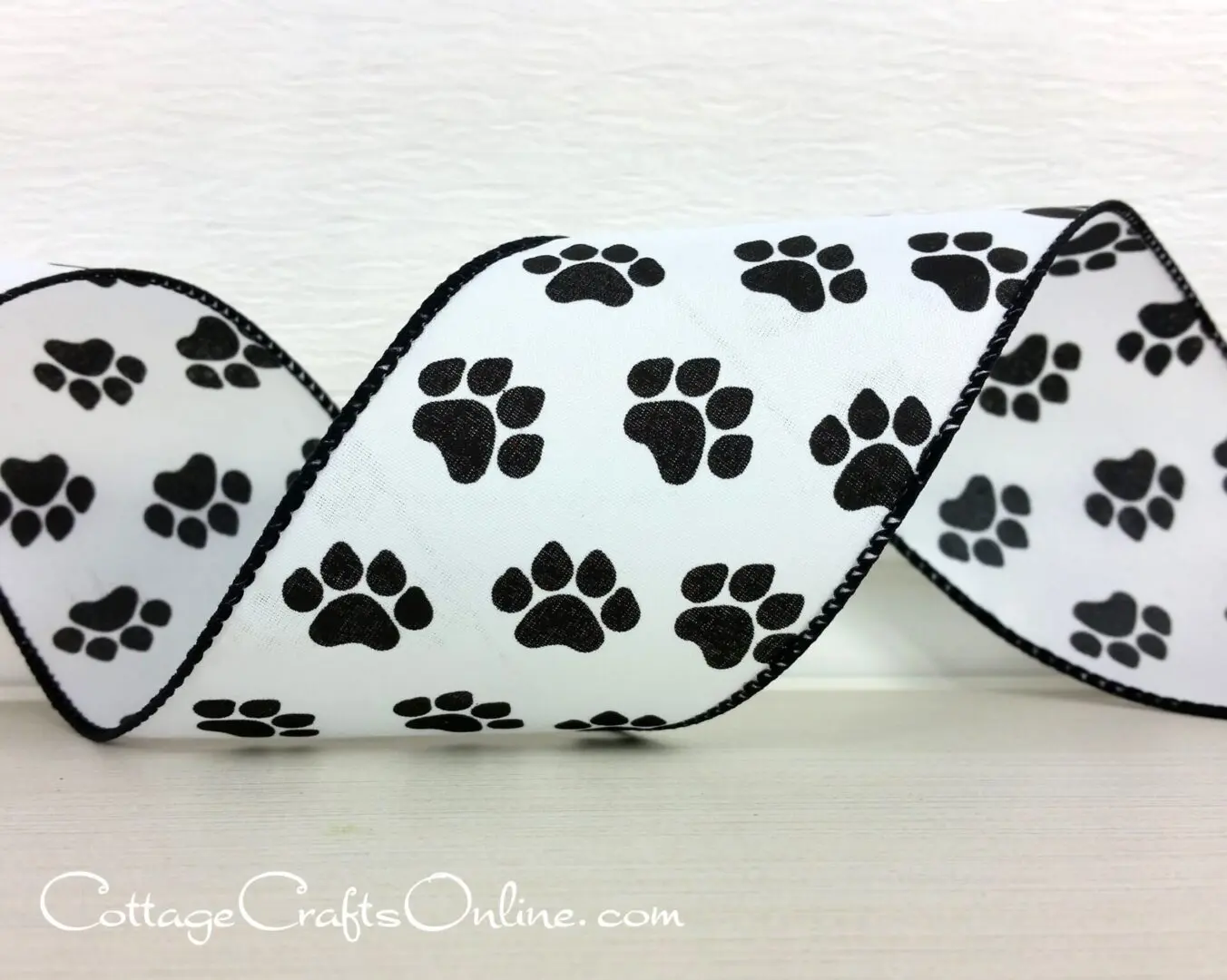 A black and white ribbon with paw prints on it