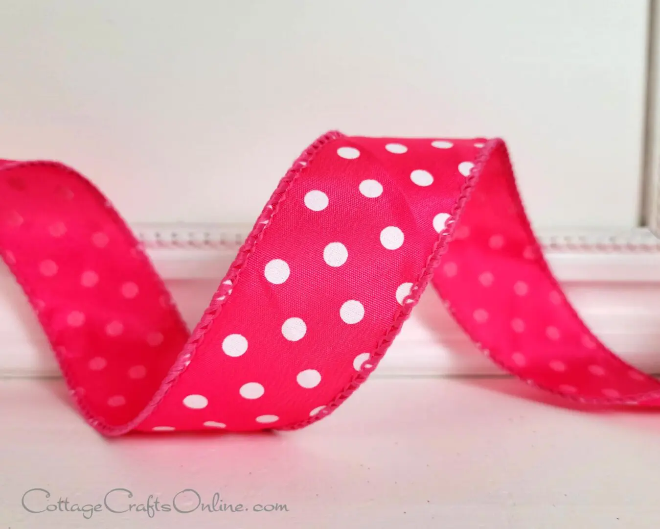 A red ribbon with white polka dots on it.