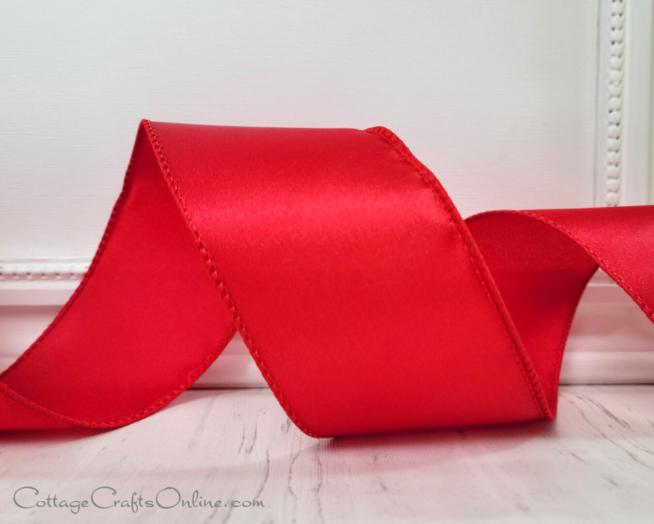 A red ribbon sitting on top of a table.