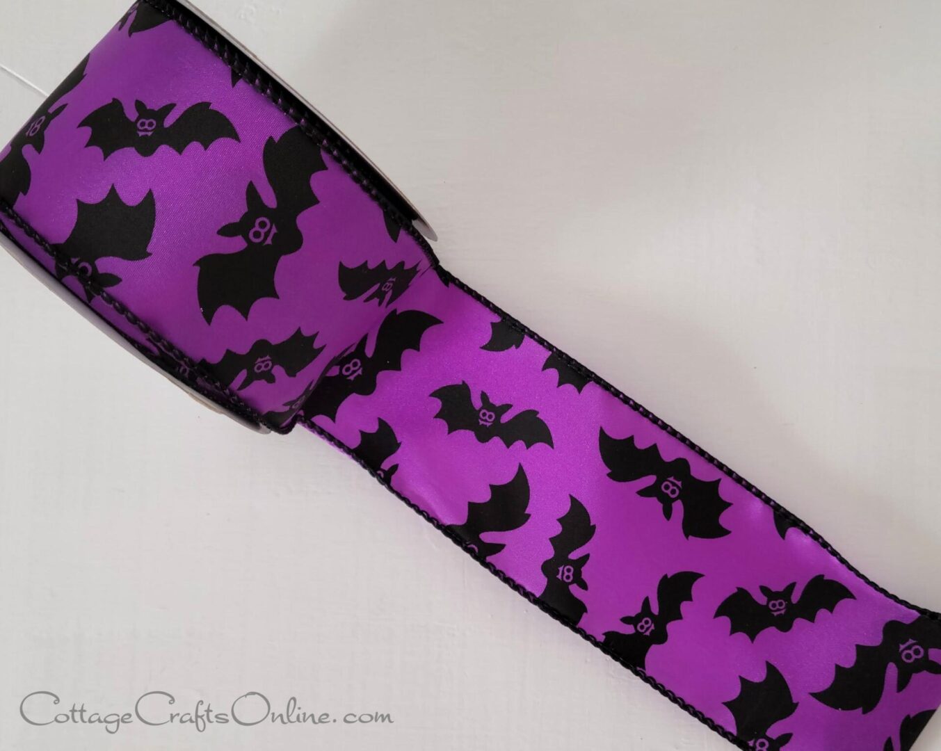 A purple ribbon with bats on it