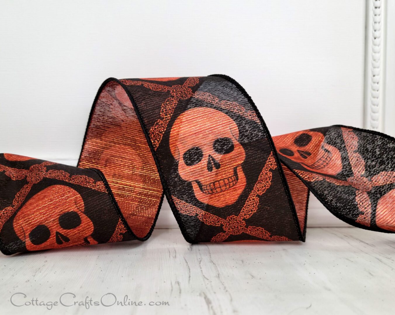 A red and black skull ribbon sitting on top of a table.
